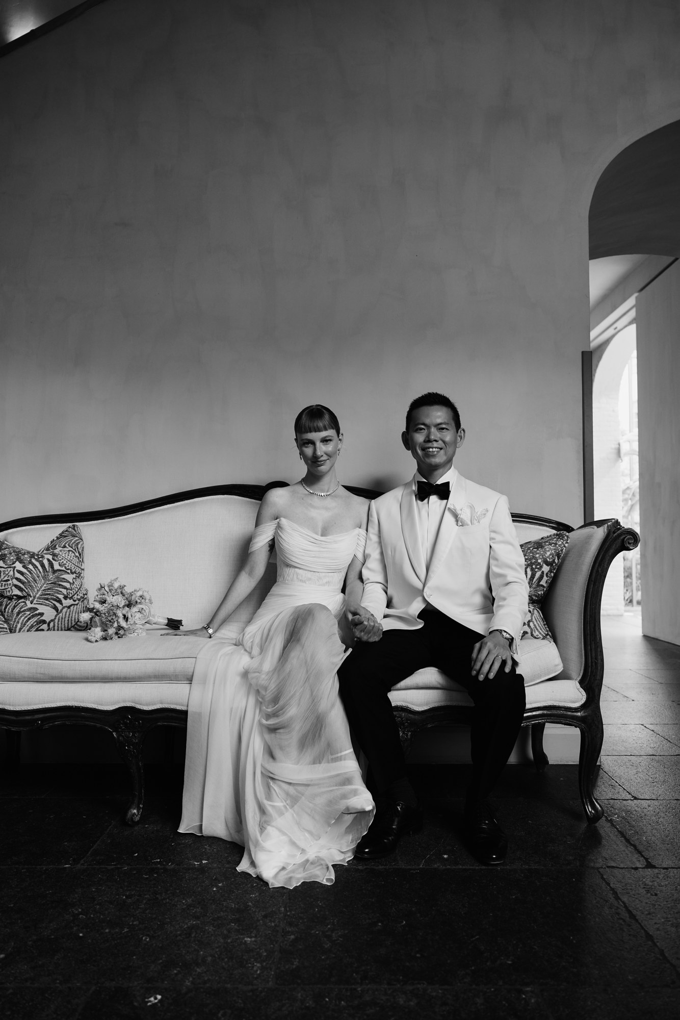 Lina and Jin seated together on their wedding day