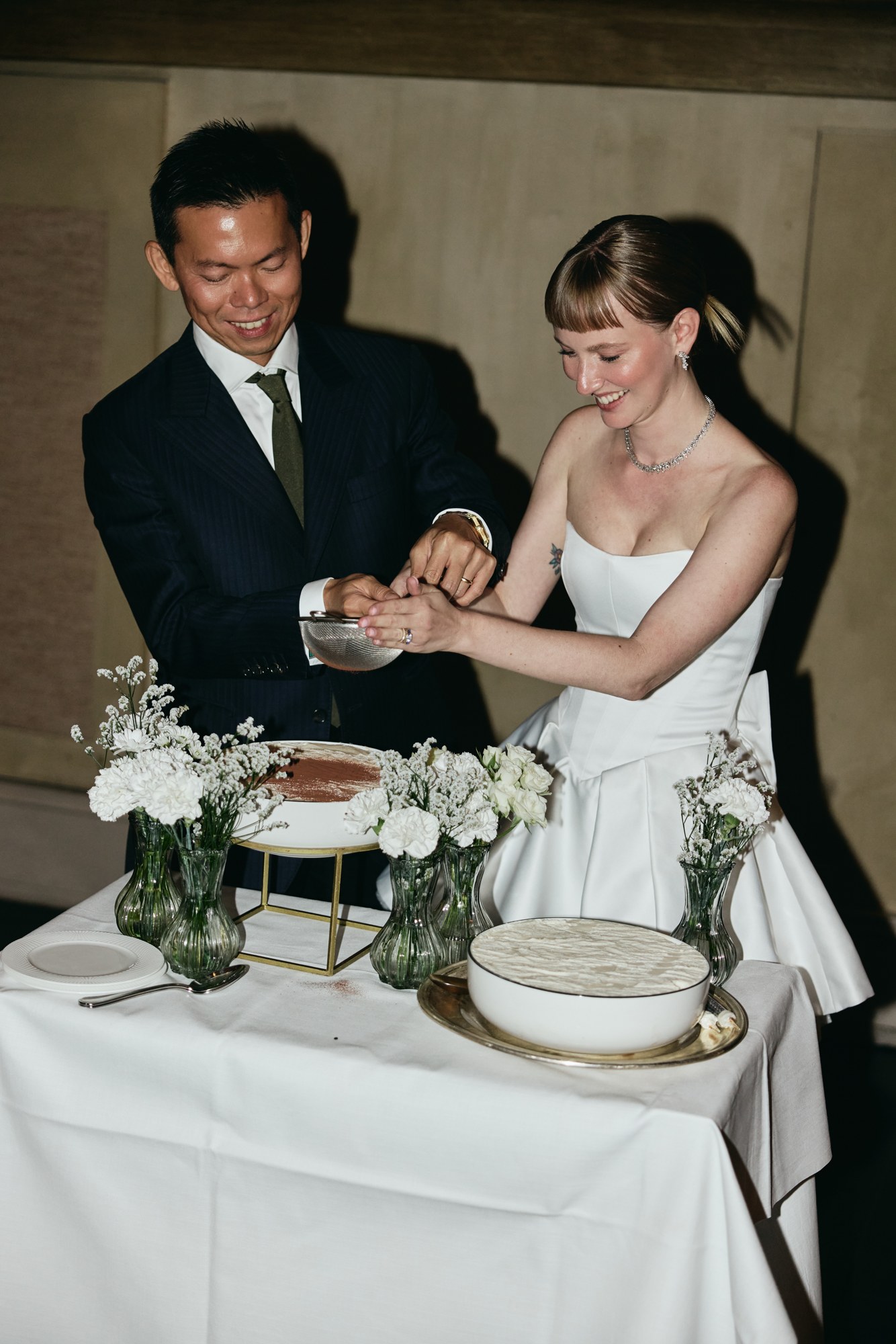 Lina and Jin cutting their wedding cake